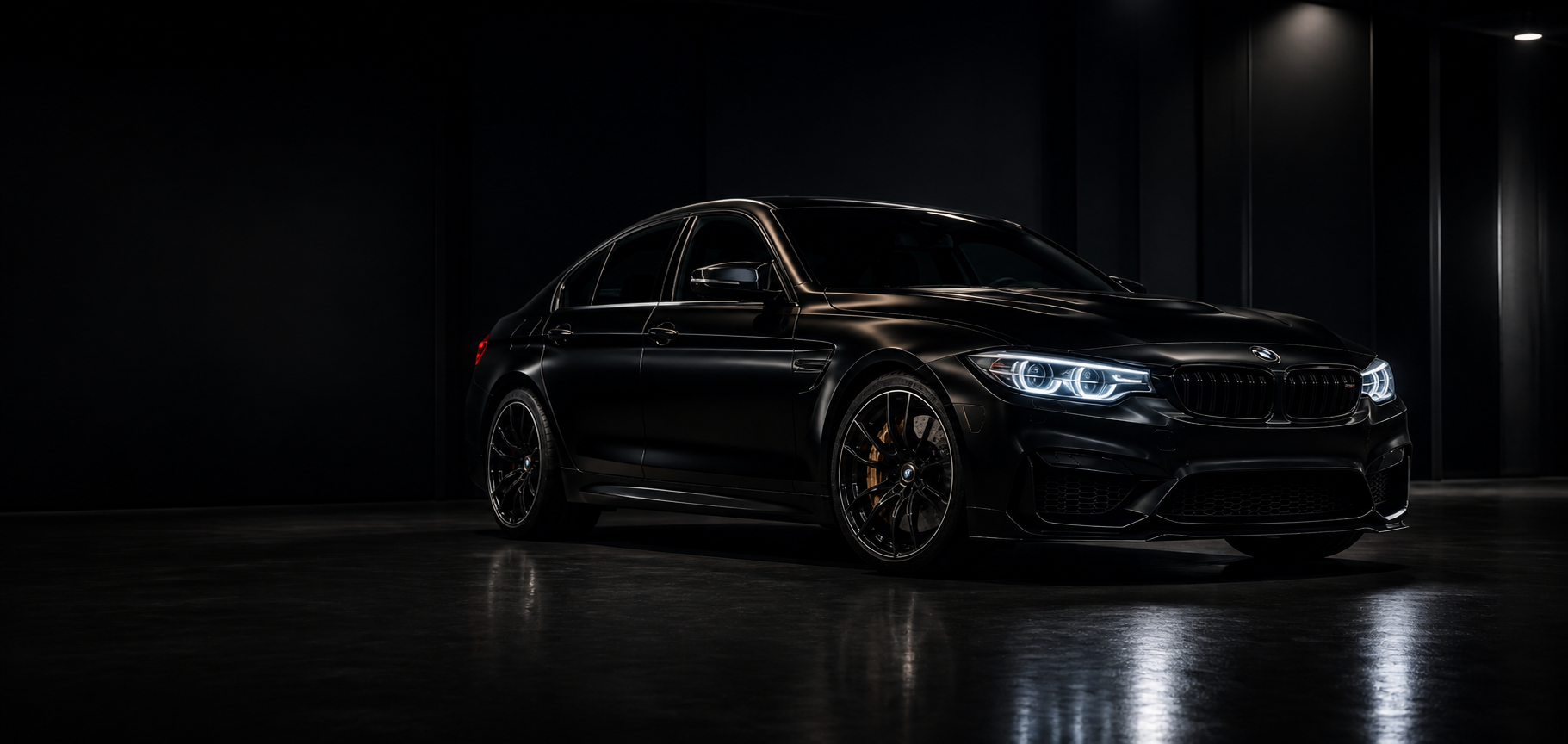 Black performance car in a dark workshop